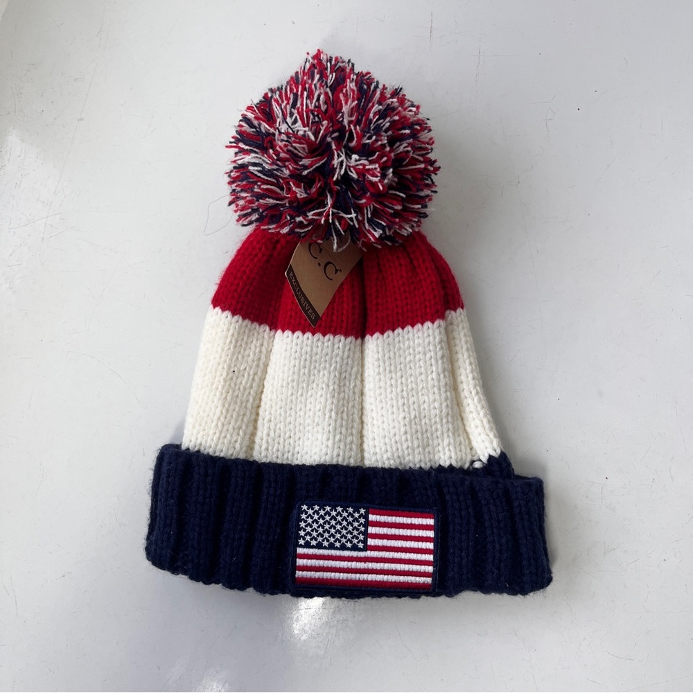 C. C Exclusive Knit beanie hat with pom - pom
American Flag on brim